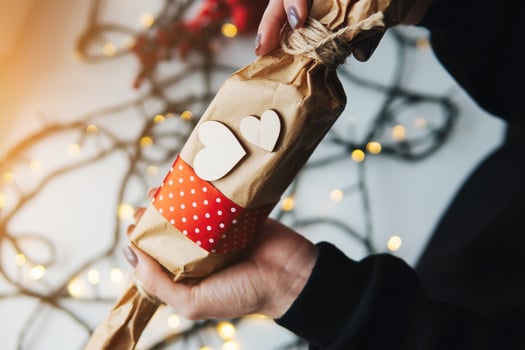 girl holding a Christmas gift in hand photo