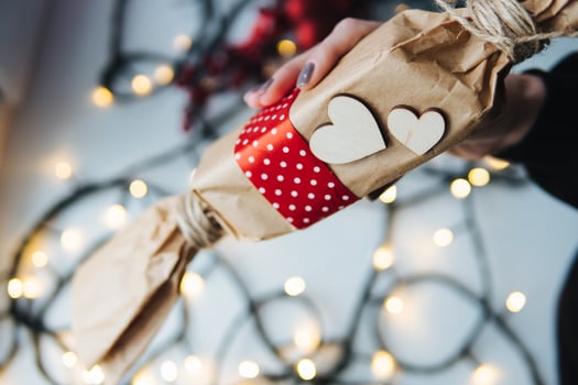 girl holding a Christmas gift in hand photo