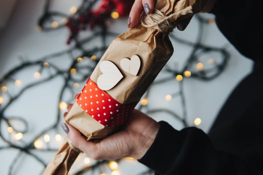 girl holding a Christmas gift in hand photo