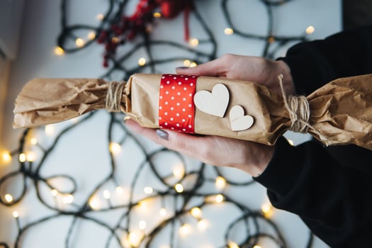 girl holding a Christmas gift in hand photo
