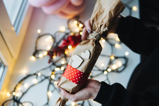 girl holding a Christmas gift in hand photo