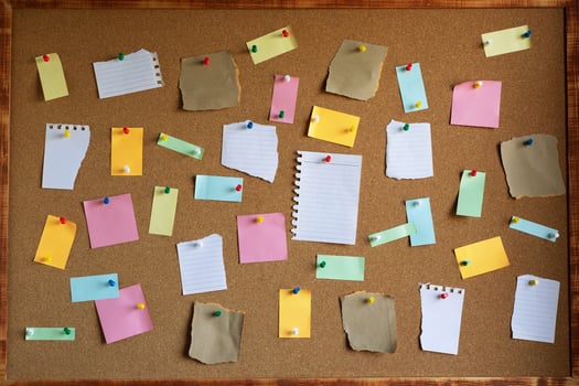 collection of colorful variety. paper note pad reminder sticky notes pin paper yellow on cork bulletin board photo