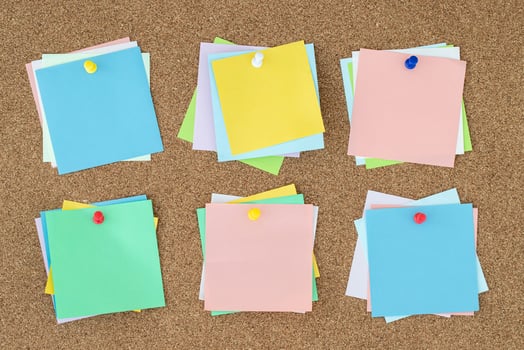 collection of colorful variety post. paper note reminder sticky notes pin on cork bulletin board. photo