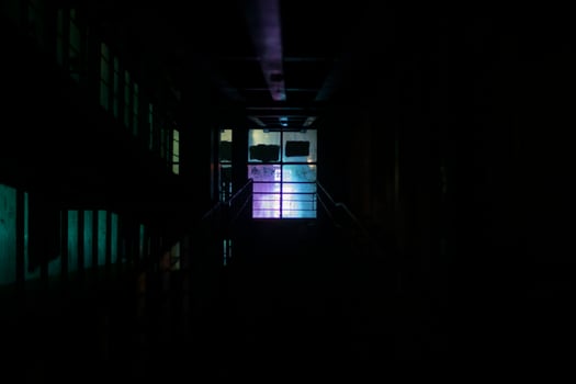 Window light in dark. Neon glow in night building. photo