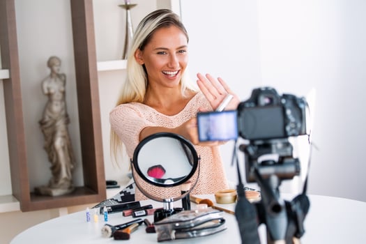 Beautiful young female blogger recording vlog video with makeup cosmetic at home online influencer on social media concept.live streaming viral photo