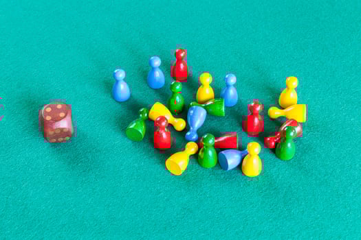 dice and wooden board game pawns on green table photo
