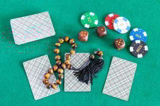 cards, wooden dices, casino tokens and worry beads photo
