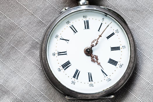 shabby pocket watch on gray textile background photo