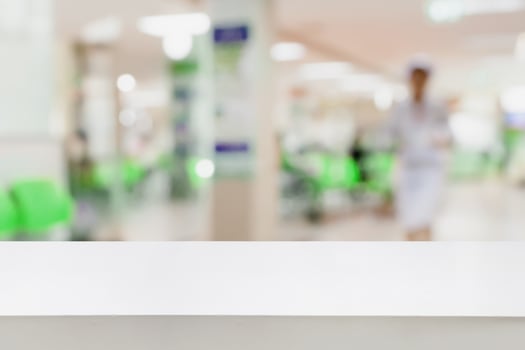 Empty white desk with blur hospital background photo
