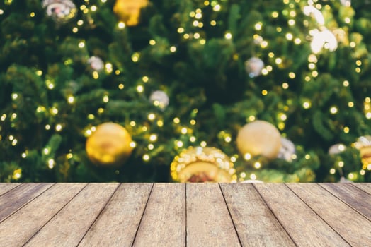 Abstract Christmas holiday bokeh light background with empty wood table for create montage product photo