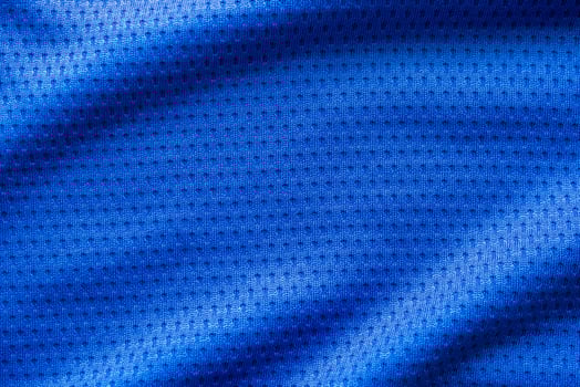 Blue color fabric sport clothing football jersey with air mesh texture background photo
