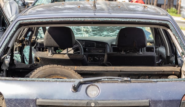 A car after an accident with a broken rear window. Broken window in a vehicle. The wreckage of the interior of a modern car after an accident, a detailed close-up view of the damaged car. photo