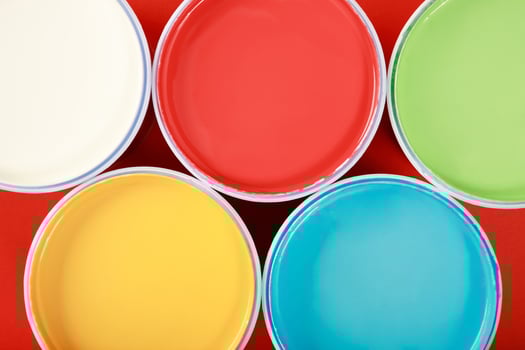 Cans of interior wall paint is placed on a red background. photo