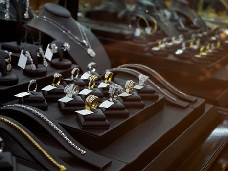 Gold jewelry diamond shop with rings and necklaces luxury retail store window display photo