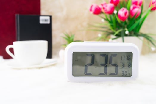 Digital clock and cup of coffee photo