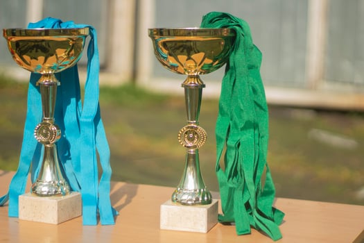 Gold Cups. Sports awards at competition. Details of football match. Products made of gold-plated steel. photo