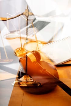 Business and lawyers discussing contract papers with brass scale on desk in office. Law, legal services, advice, justice and law concept picture with film grain effect photo