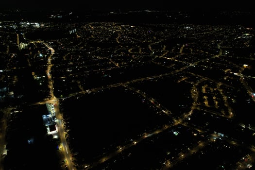 Night Aerial View of Illuminated British City. Drone's Footage of Luton Town of England at Night photo