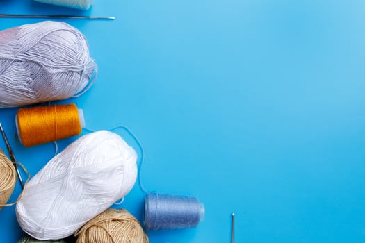 Skeins of wool yarn and knitting needles photo