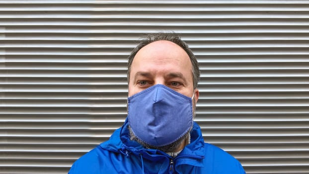 middle aged man wearing cloth face mask or community mask during corona covid-19 pandemic photo