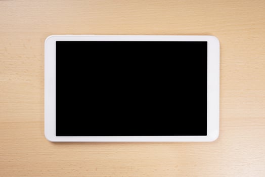 tablet computer with blank display on wooden desk photo