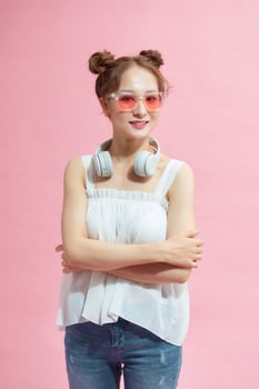 Young asian woman over isolated background keeping the arms crossed in frontal position photo
