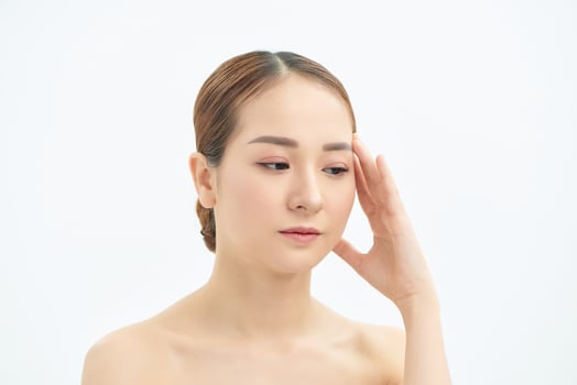 Portrait of tired and upset Asian woman over white background photo