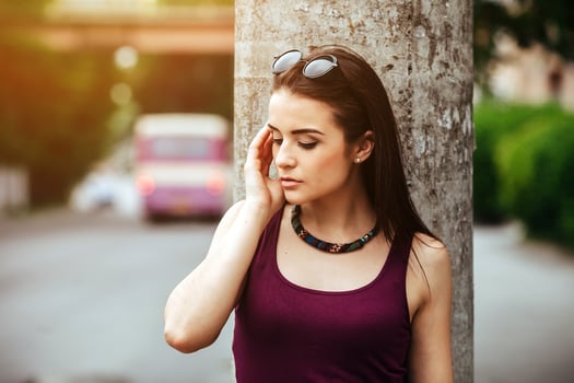 pretty girl sitting in a city street photo