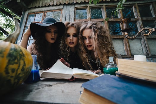 Three vintage witches perform magic ritual photo