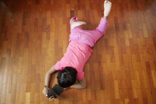 child hand pointing finger on digital tablet screen on floor top view photo