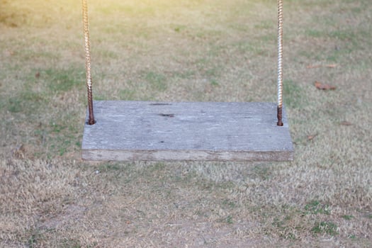 Empty swings on the countryside playground. photo