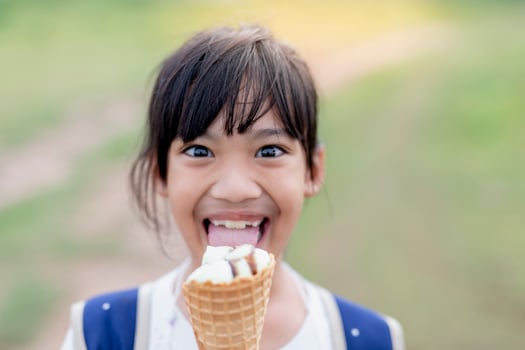 Portrait of a cute girl with ice cream on a walk in the park. child outdoors photo