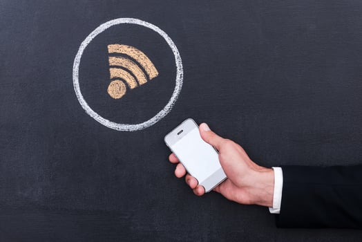 Connecting the internet. Concept of human hand holding telephone against sharing  symbol chalk drawing on blackboard photo