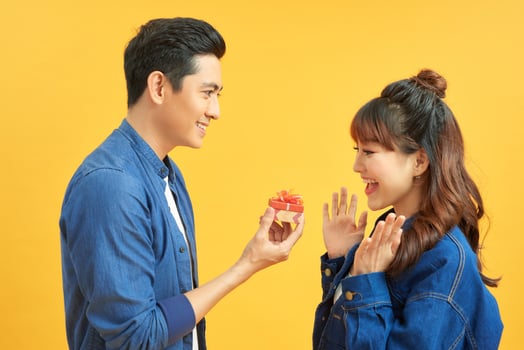 Young handsome asian man surprisingly ask her girlfriend for proposal. photo