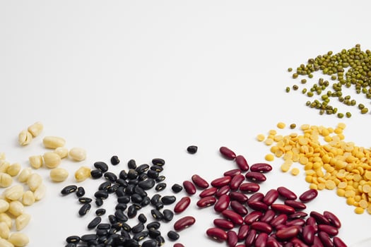 Mix beans white beans, black beans, red bean, soy beans, green mung with copy space on white background. Top view or flat lay. photo