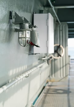 Deck lamp on ship in protective cage photo