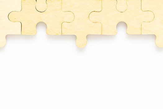 wooden jigsaw puzzle pieces on white background photo