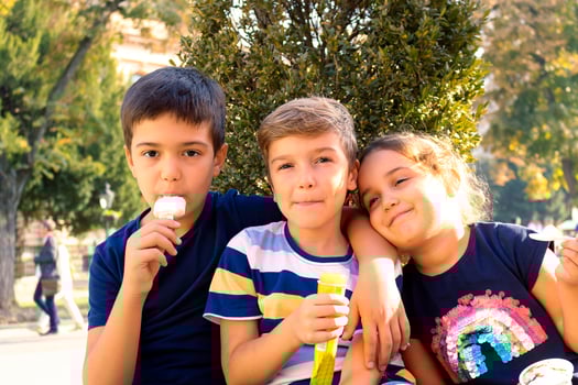 Embraced kids eating ice cream in the city. photo
