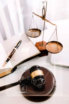 Business and lawyers discussing contract papers with brass scale on desk in office. Law, legal services, advice, justice and law concept picture with film grain effect photo
