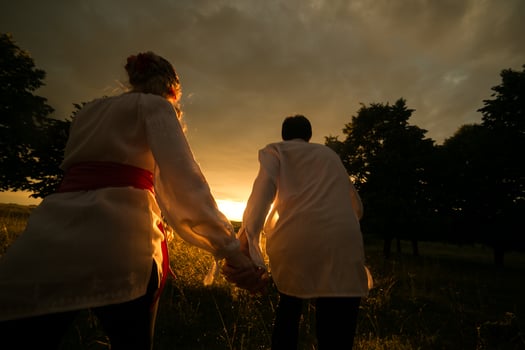 Couple running to the sunset photo