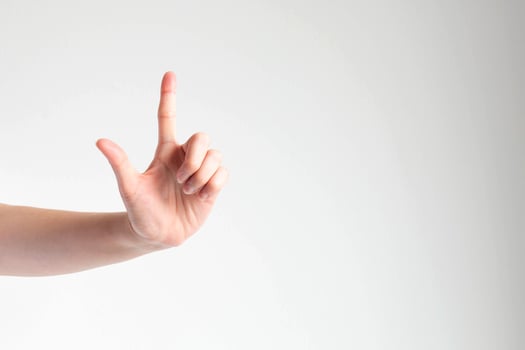 A hand raising the forefinger to touching something in front view. photo