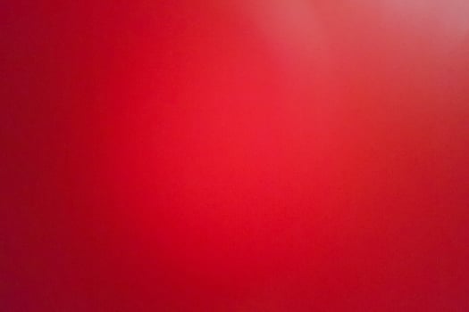 background of red leather shoot blurry and grainy by mobile camera. photo