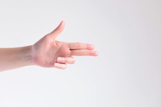 A hand pose to be gun shape on white background. photo