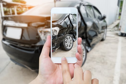 female hold mobile smartphone photographing car accident photo