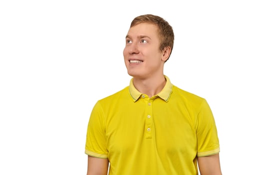 Portrait of funny young male in yellow T-shirt looking right isolated on white background photo