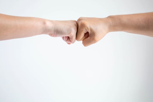 The fists bumping together on white background. photo