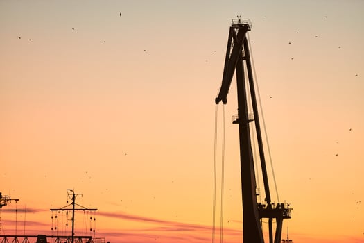 Silhouette of container crane on sunset background photo