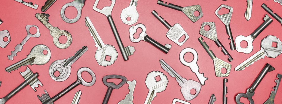 Keys set on pink background. Door lock keys and safes for proper photo