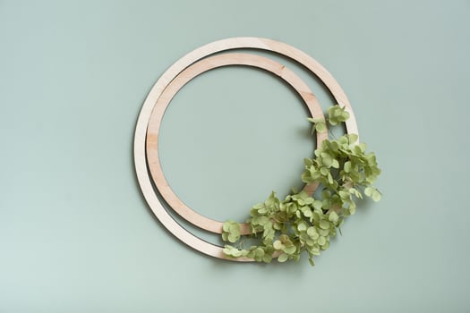Wooden frame top view with copy space decorated with dry hydrangea flowers on colored background with copy space decorated with dry hydrangea flowers on colored background photo