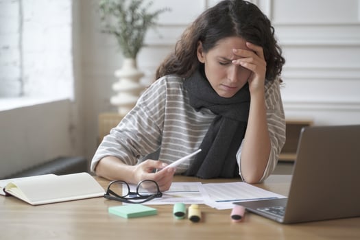 Young latin woman office worker sitting at table with digital thermometer in hand photo